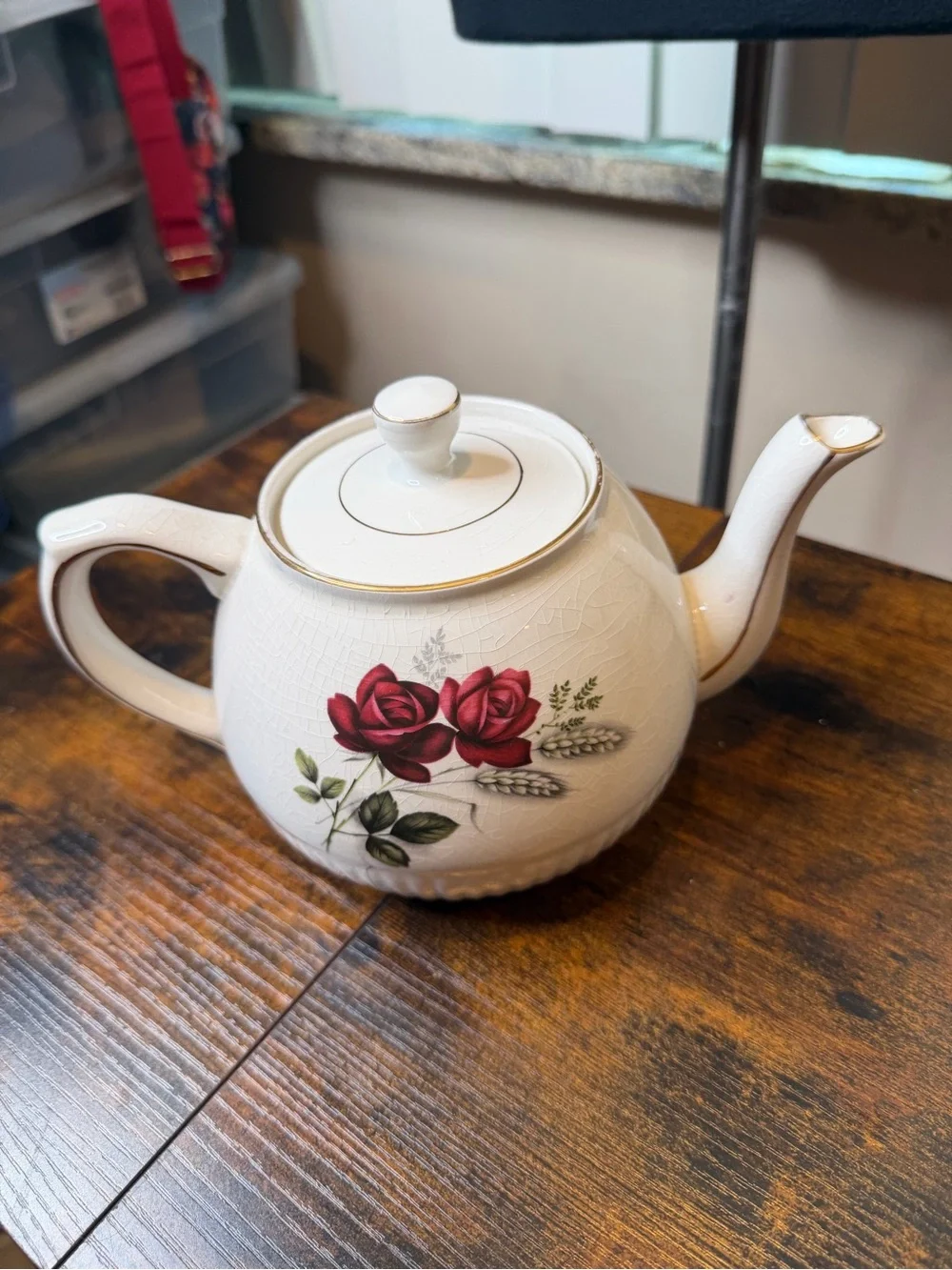 Vintage Ellgreave England red rose teapot featuring delicate gold trim.